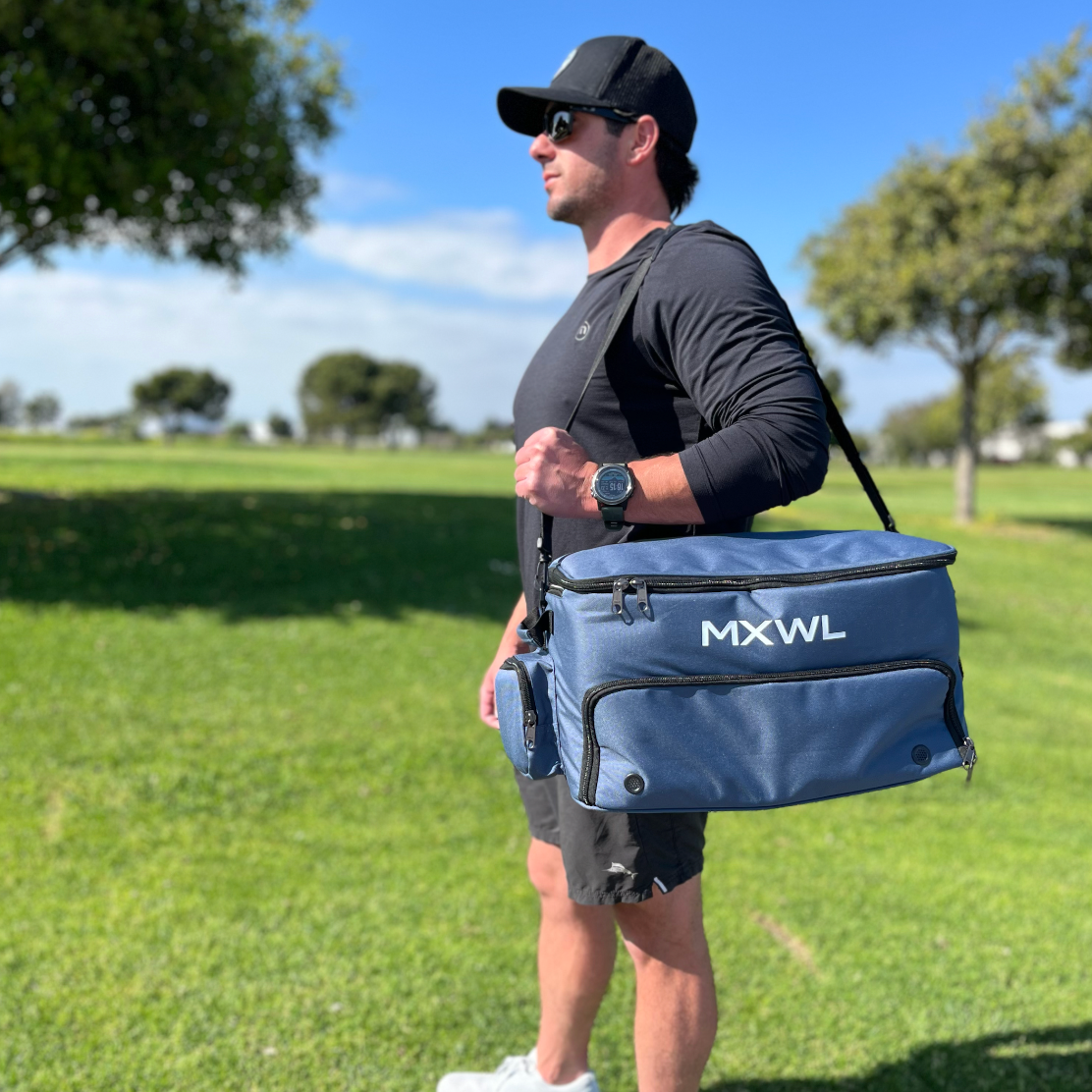 Man holding MXWl bag on golf course